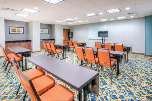 a conference room with tables and chairs and a screen at Fairfield Inn & Suites by Marriott Winston-Salem Downtown in Winston-Salem