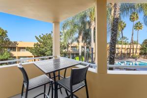 a balcony with a table and chairs and a pool at Fairfield Inn and Suites by Marriott San Jose Airport in San Jose