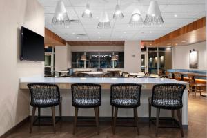 a lobby with a bar with chairs and a restaurant at Fairfield Inn & Suites by Marriott Winnemucca in Winnemucca