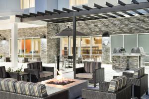an outdoor patio with chairs and a fire pit at TownePlace Suites by Marriott Leesburg in Leesburg