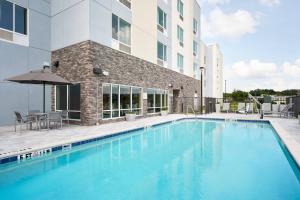 a large swimming pool in front of a building at TownePlace Suites by Marriott Leesburg in Leesburg