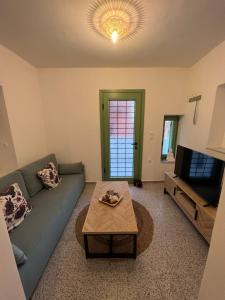 a living room with a couch and a coffee table at La Casa Verde in Ermoupoli