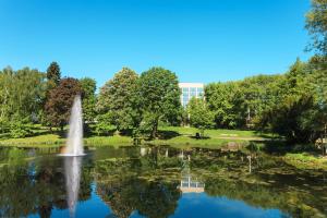 a fountain in a pond in a park at Sheraton Essen Hotel in Essen +97 photos