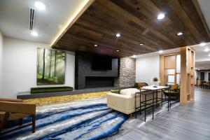 a living room with a couch and a large rug at Fairfield by Marriott Inn & Suites Louisville Airport in Louisville