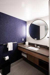 a bathroom with a sink and a mirror at Fairfield by Marriott Inn & Suites Louisville Airport in Louisville