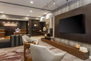 a living room with a flat screen tv on a wall at Courtyard Tampa Brandon in Tampa
