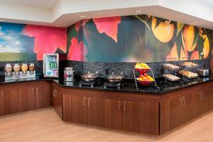 a kitchen with a counter with food on it at Fairfield Inn & Suites South Bend Mishawaka in South Bend