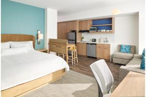 a hotel room with a bed and a kitchen at Element Nashville Airport in Nashville
