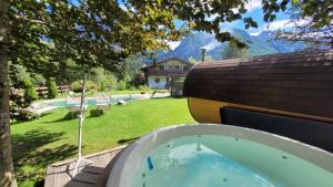 a hot tub in the backyard of a house at Aqua Apartments Spa Housemuhlbach in Sappada