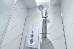 a shower in a bathroom with a shower head at Rooms at Rolleston in Rolleston