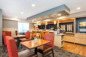 a restaurant with a table and chairs and a kitchen at TownePlace Suites Denver Tech Center in Centennial