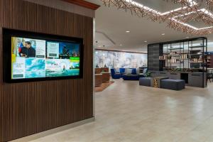 a lobby with a flat screen tv on a wall at Courtyard Austin Downtown/Convention Center in Austin
