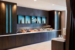 a restaurant with a counter with food on it at SpringHill Suites by Marriott Hartford Cromwell in Cromwell