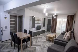 a living room with a couch and a table at C&Y Zev Apartments in Mamaia