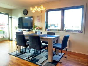 a dining room with a table and chairs at Top floor city center flat with free parking in Oslo
