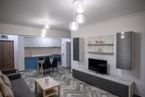 a living room with a couch and a fireplace at C&Y Zev Apartments in Mamaia