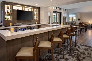 a bar in a hotel with chairs and a tv at Residence Inn by Marriott Charleston Summerville in Summerville