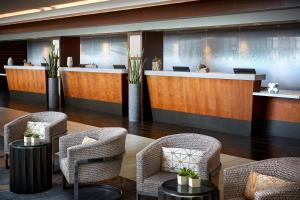 a hotel lobby with chairs and a reception desk at San Francisco Airport Marriott Waterfront in Burlingame