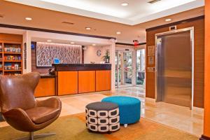 a living room with a chair and a stool at Fairfield Inn & Suites by Marriott Frederick in Frederick