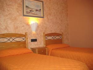 Postel nebo postele na pokoji v ubytování Hostal Guarni