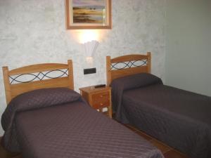 Postel nebo postele na pokoji v ubytování Hostal Guarni