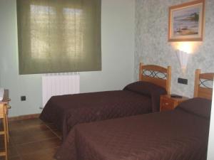 Postel nebo postele na pokoji v ubytování Hostal Guarni