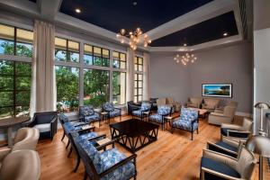 a large room with chairs and tables and windows at Marriott's Heritage Club in Hilton Head Island