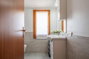 a bathroom with a sink and a toilet and a window at Casa Delle Pleiadi in Torre delle Stelle