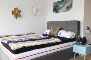 a bed with a gray headboard in a bedroom at Apartment Tälerblick Maxi -neu modernisiert- in Böbrach