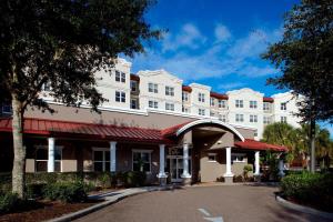 a large white hotel building with a parking lot at Residence Inn Tampa Suncoast Parkway at NorthPointe Village in Lutz