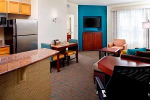 a hotel room with a kitchen and a living room at Residence Inn Tampa Suncoast Parkway at NorthPointe Village in Lutz