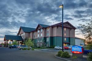 a hotel with cars parked in a parking lot at Fairfield Inn & Suites by Marriott Anchorage Midtown in Anchorage