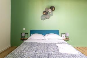 une chambre avec un grand lit et une tête de lit bleue dans l'établissement F3 Grand Luxe Champfleuri (B), à Clermont-Ferrand