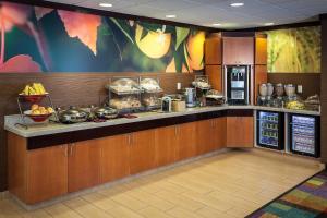 a restaurant kitchen with a counter with food on it at Fairfield Inn & Suites by Marriott Anchorage Midtown in Anchorage