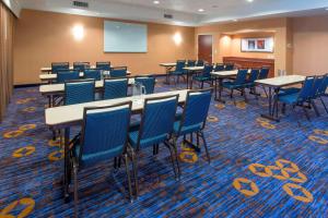 a conference room with tables and chairs and a screen at Courtyard by Marriott Montgomery Prattville in Prattville