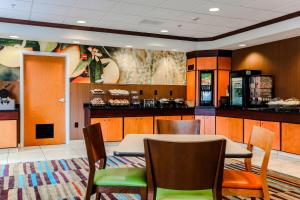 a restaurant with a table and chairs and a counter at Fairfield by Marriott Wilkes-Barre in Wilkes-Barre