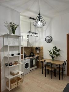 a kitchen with a table and a dining room at ANNA'S APARTMENT in Rome
