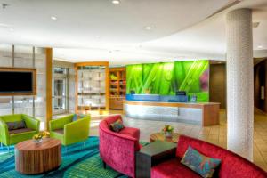 a lobby with colorful furniture and a flat screen tv at SpringHill Suites by Marriott Bellingham in Bellingham