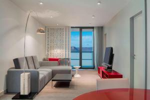 a living room with a couch and a tv at Le Meridien Oran Hotel in Oran