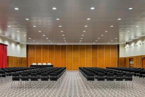 an empty lecture hall with black chairs and a red curtain at Le Meridien Oran Hotel in Oran +62 photos