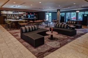 a lobby with couches and tables and a bar at Courtyard Austin by Marriott Northwest/Lakeline in Austin