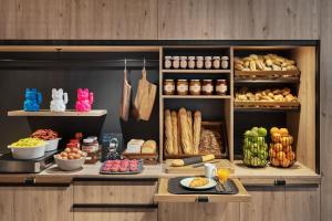 a bakery counter with lots of different types of food at Moxy Amiens in Amiens