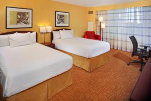 a hotel room with two beds and a desk at Courtyard by Marriott Baltimore Downtown/Inner Harbor in Baltimore
