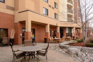a patio with a table and chairs in front of a building at Courtyard by Marriott Toronto Brampton in Brampton