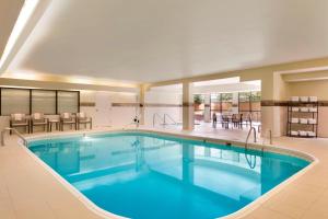 a large swimming pool in a hotel room at Courtyard by Marriott Bloomington Normal in Bloomington