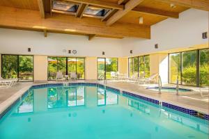 a swimming pool in a house with glass windows at Fairfield Inn by Marriott Bangor in Bangor