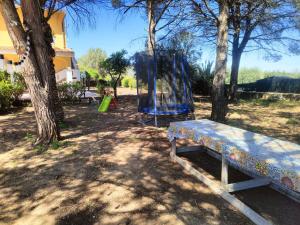 a park with a bench and a playground at Villa Gioia Relais in Avola