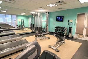 a gym with several treadmills and exercise machines at Residence Inn Newport News Airport in Newport News
