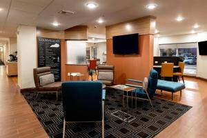a waiting room with chairs and a chalkboard at TownePlace Suites by Marriott Louisville Airport in Louisville