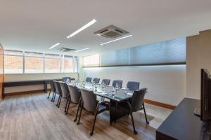 uma sala de conferências com uma mesa longa e cadeiras em Tryp by Wyndham Belo Horizonte Savassi em Belo Horizonte